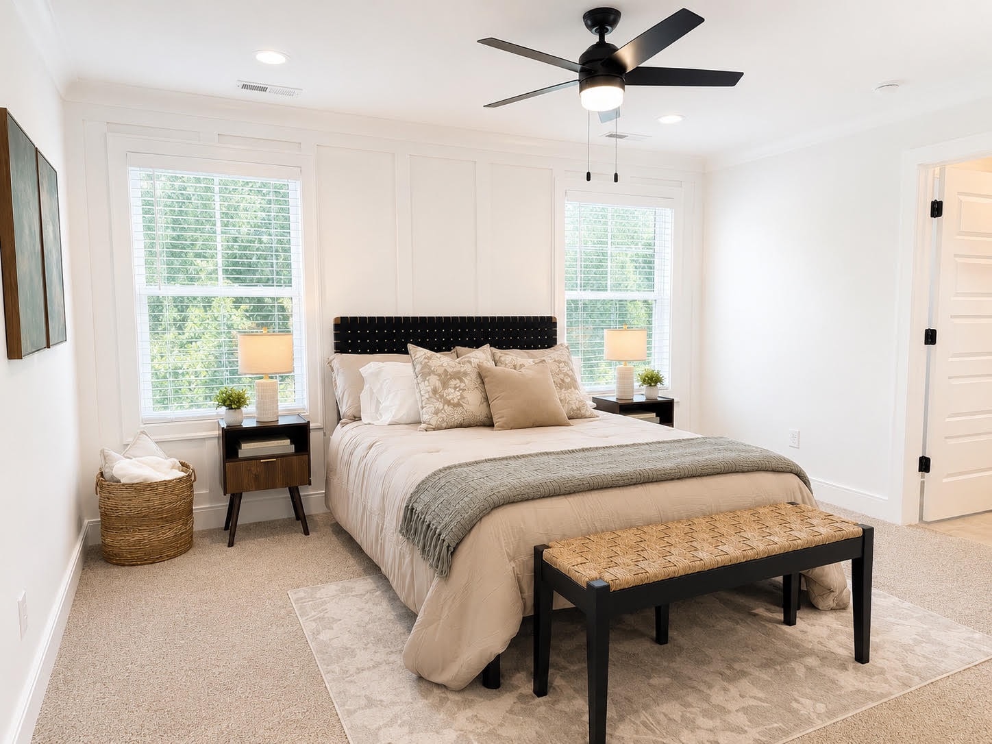 Staged master bedroom with tufted headboard and neutral linens