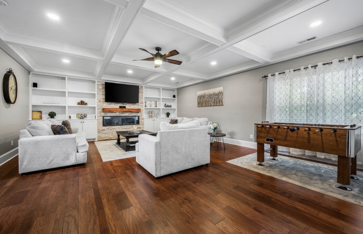 Staged living room with coffered ceiling and built-ins